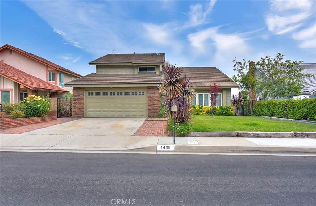 1449 Rolling Knoll Road Diamond Bar, CA 91765 - Photo 1 of 1 a front view of a house with a yard and a garage