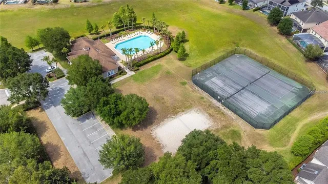 an aerial view of a house with a yard and lake view