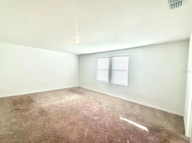 an empty room with a windows