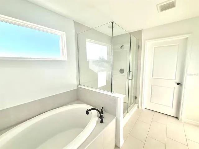 a bathroom with a bathtub and a shower