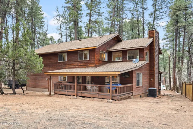 a view of a patio with table and chairs with wooden fence and plants