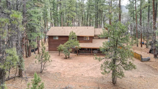 an aerial view of a house with yard and outdoor seating