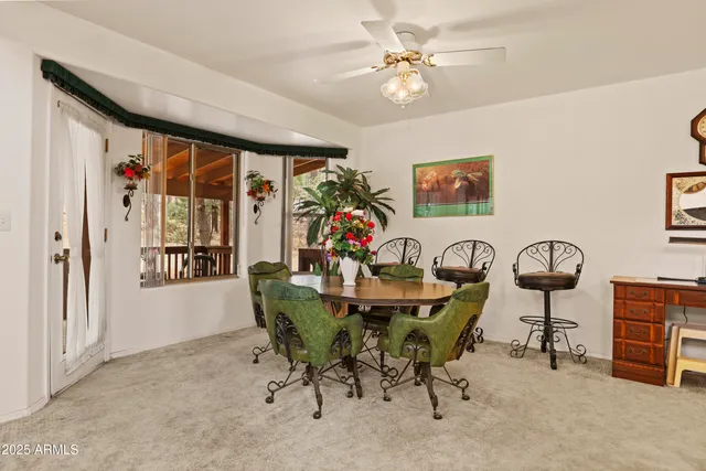 a view of a livingroom with furniture and a ceiling fan
