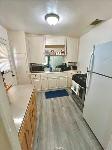 a kitchen with sink and refrigerator