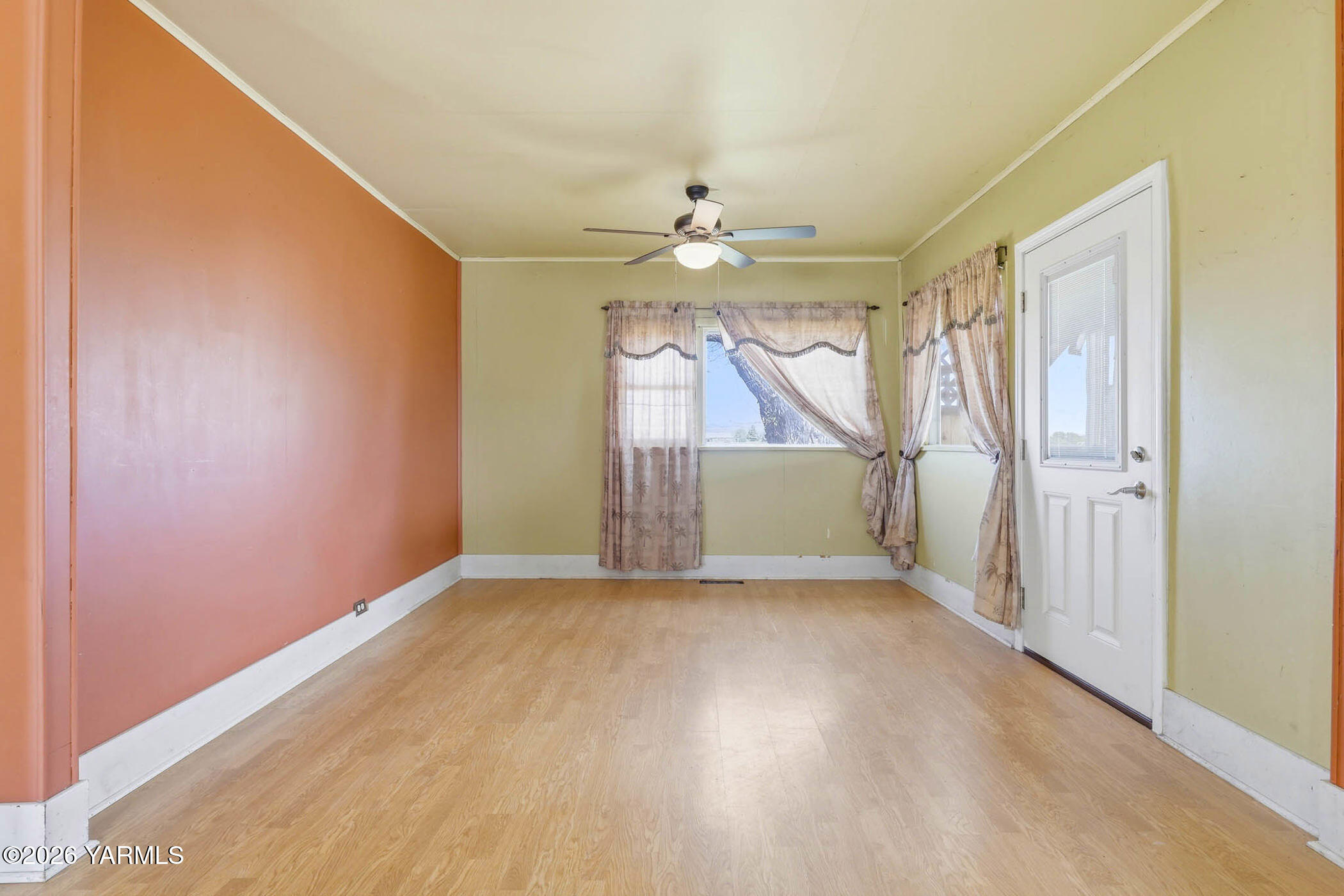 721 Blaine Road Granger, WA 98932 - Photo 12 of 45 an empty room with chandelier fan and wooden floor