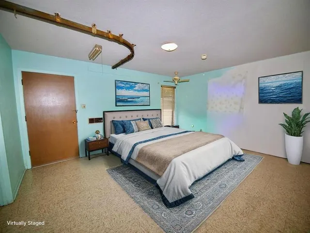 a bedroom with a bed and a night stand