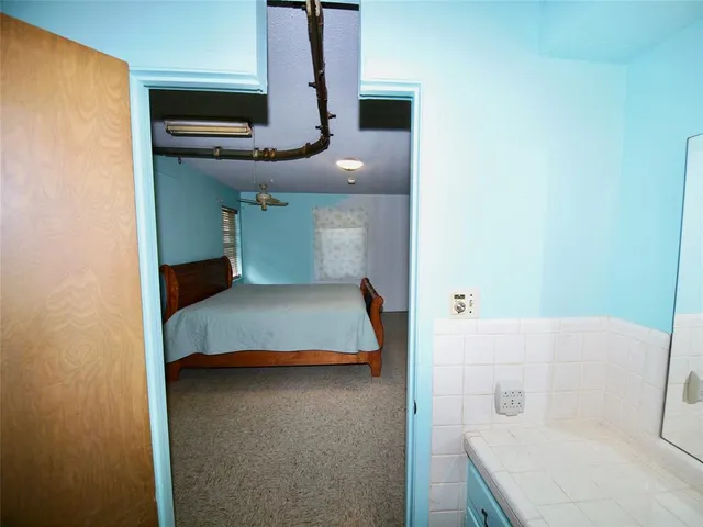 a bedroom with a bed and a mirror