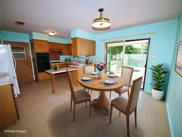a view of a dining room with furniture window and outside view