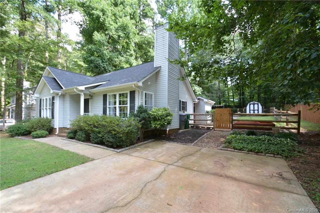 324 Radio Road, Unit 4 Charlotte, NC 28216 - Photo 2 of 19 a front view of a house with a yard and green space