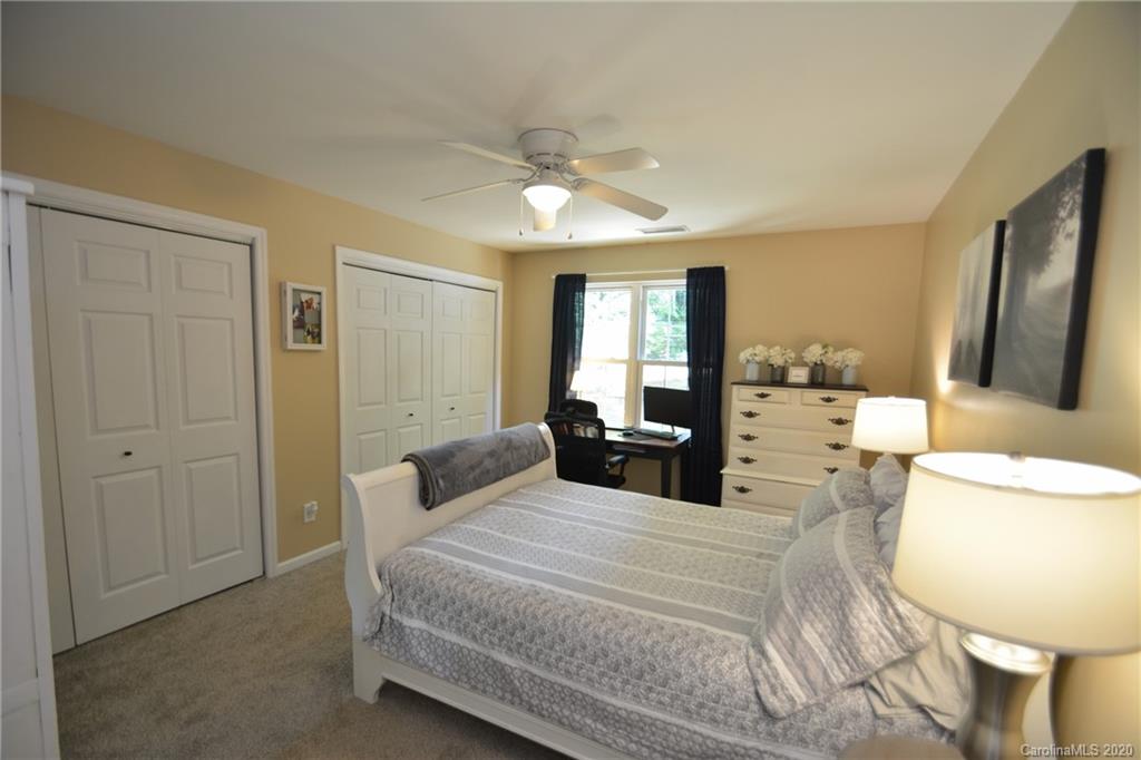 324 Radio Road, Unit 4 Charlotte, NC 28216 - Photo 11 of 19 a spacious bedroom with a large bed a chandelier and closet