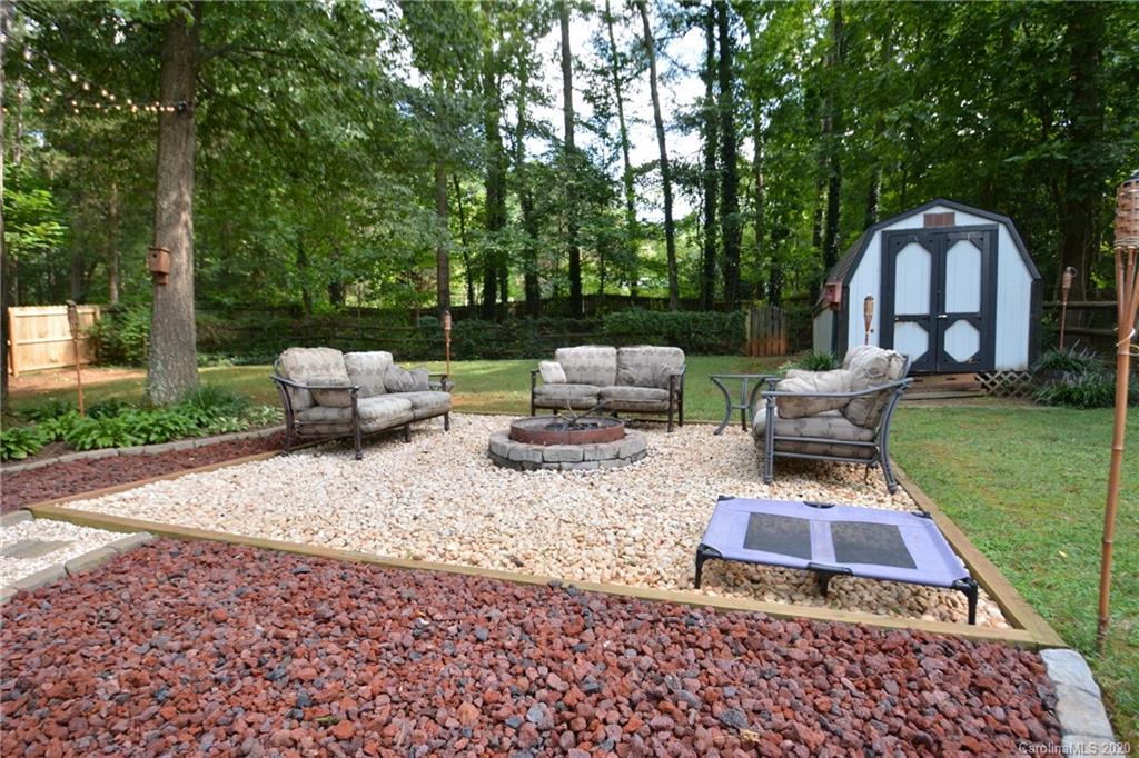 324 Radio Road, Unit 4 Charlotte, NC 28216 - Photo 17 of 19 a backyard of a house with table and chairs