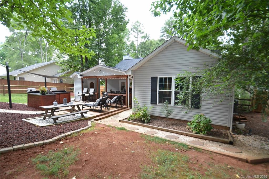 324 Radio Road, Unit 4 Charlotte, NC 28216 - Photo 19 of 19 a patio with a table and chairs under an umbrella