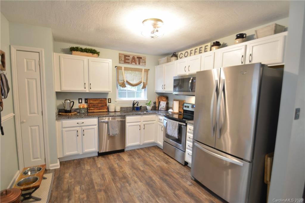324 Radio Road, Unit 4 Charlotte, NC 28216 - Photo 3 of 19 a kitchen with stainless steel appliances a refrigerator sink and microwave