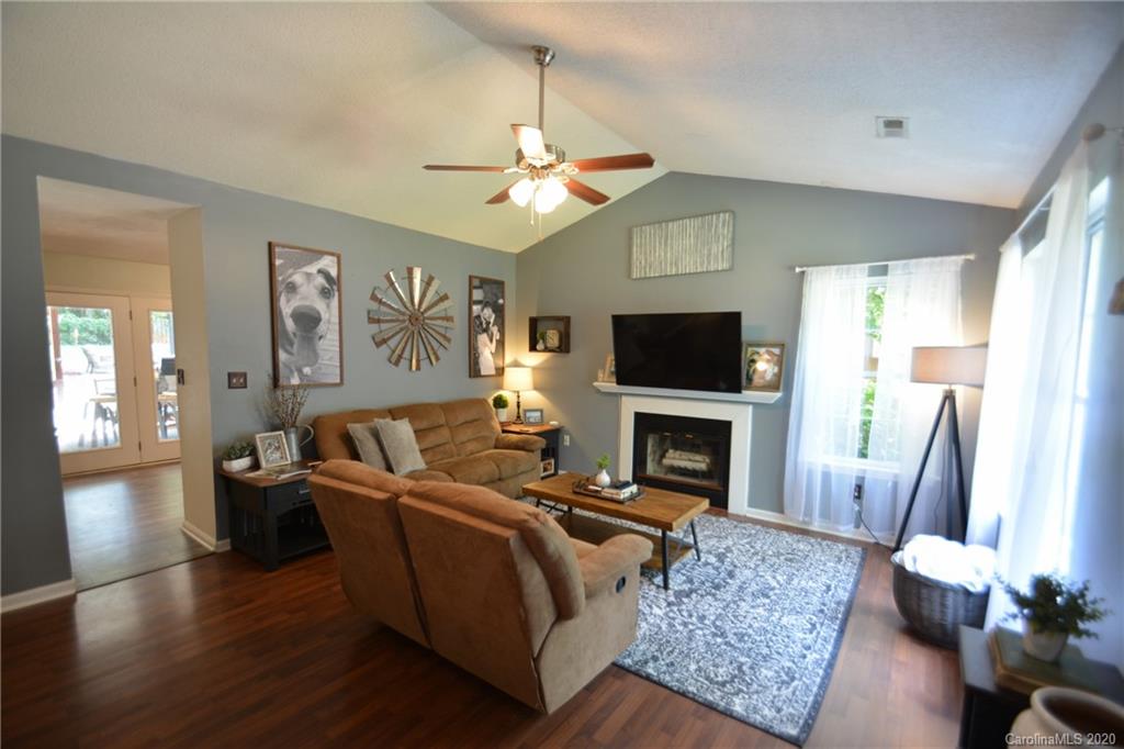 324 Radio Road, Unit 4 Charlotte, NC 28216 - Photo 6 of 19 a living room with furniture a fireplace and a flat screen tv