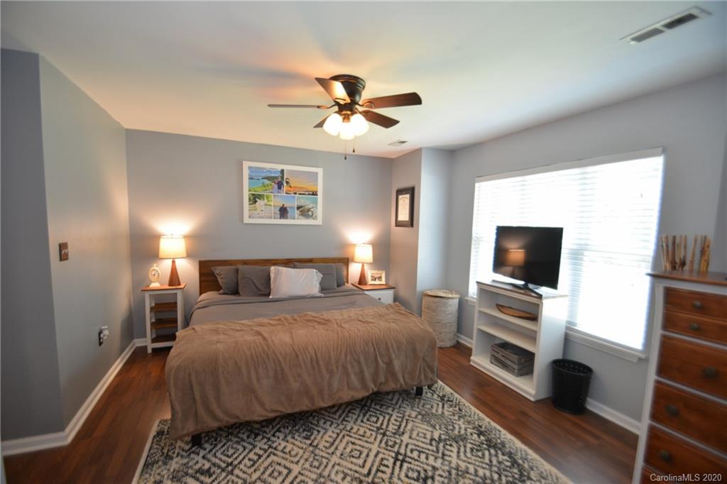 324 Radio Road, Unit 4 Charlotte, NC 28216 - Photo 8 of 19 a bedroom with a bed and a flat screen tv