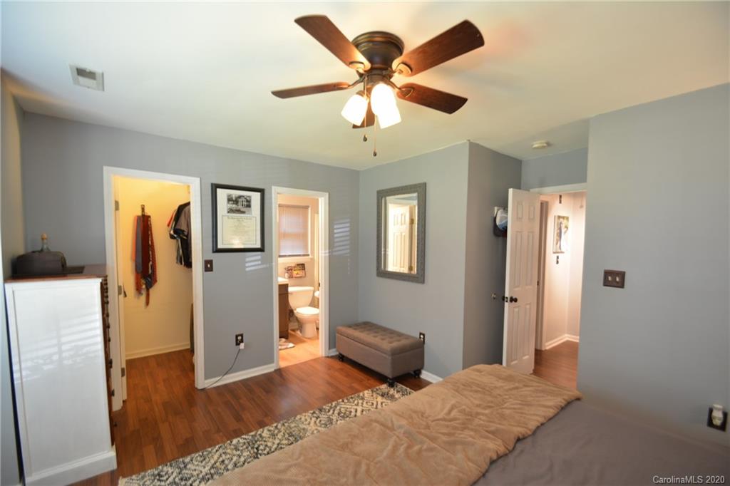 324 Radio Road, Unit 4 Charlotte, NC 28216 - Photo 9 of 19 a bedroom with a bed and a chandelier