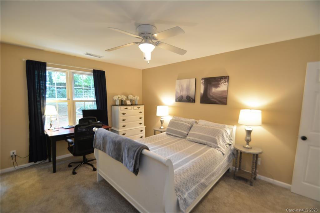 324 Radio Road, Unit 4 Charlotte, NC 28216 - Photo 10 of 19 a bedroom with a bed and a chandelier