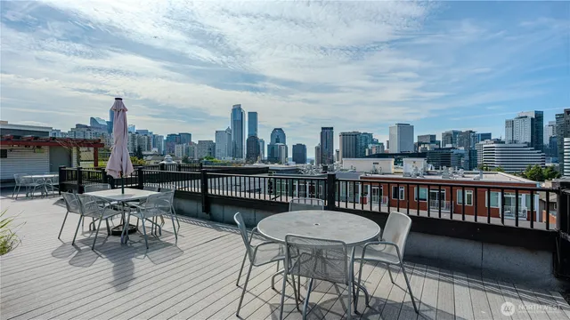 a view of a roof deck with table and chairs and wooden floor
