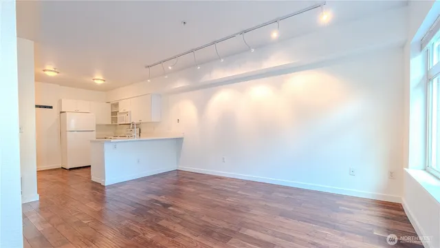 a view of a kitchen with a sink and wooden floor