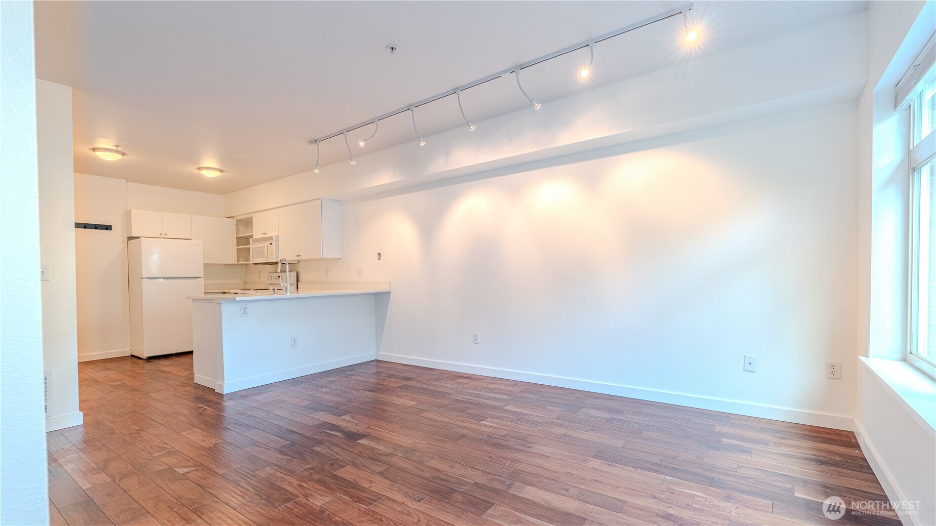 1620 Belmont Avenue, Unit 226 Seattle, WA 98122 - Photo 4 of 19 a view of a kitchen with a sink and wooden floor