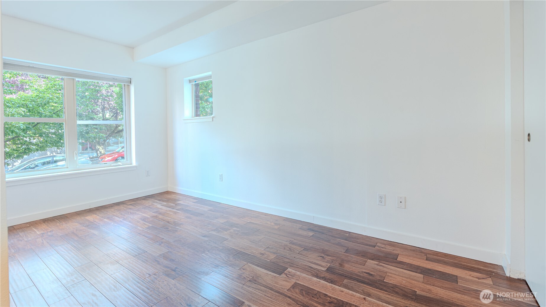 1620 Belmont Avenue, Unit 226 Seattle, WA 98122 - Photo 6 of 19 an empty room with wooden floor and windows