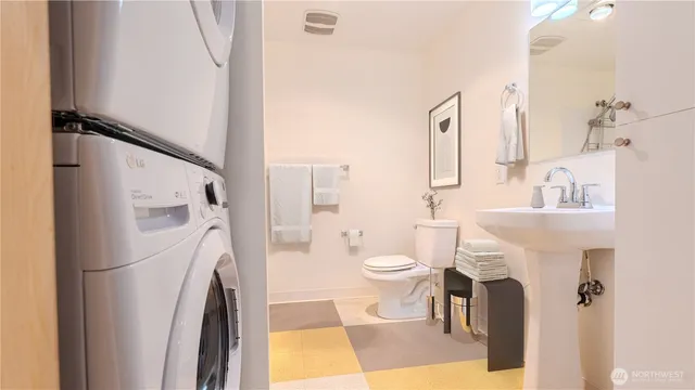a white toilet sitting next to a bathroom sink