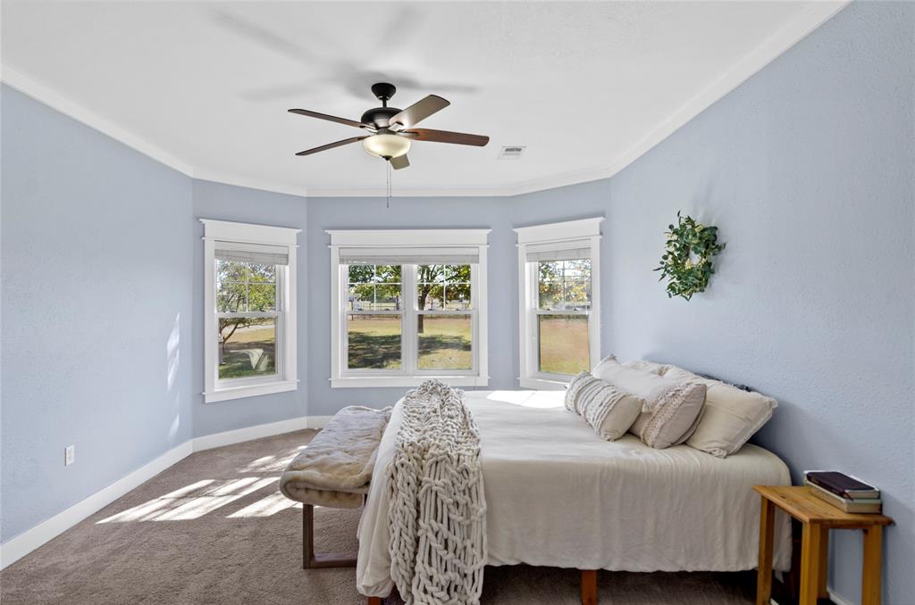 14728 Songbird Lane Haslet, TX 76052 - Photo 14 of 40 a bedroom with a bed a window and a chandelier