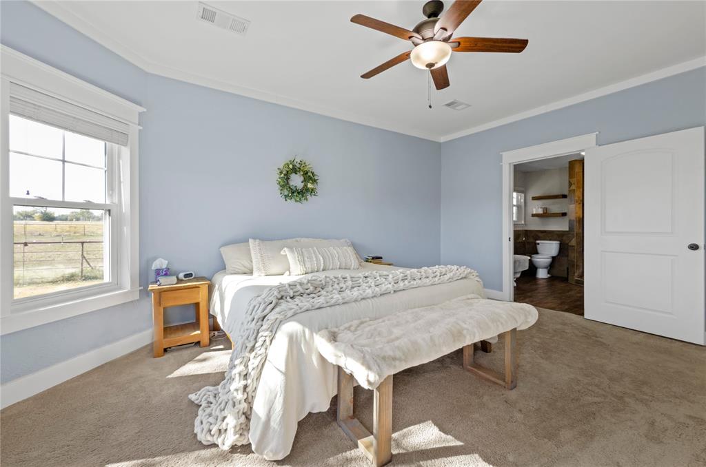 14728 Songbird Lane Haslet, TX 76052 - Photo 15 of 40 a bed sitting in a bedroom next to a window