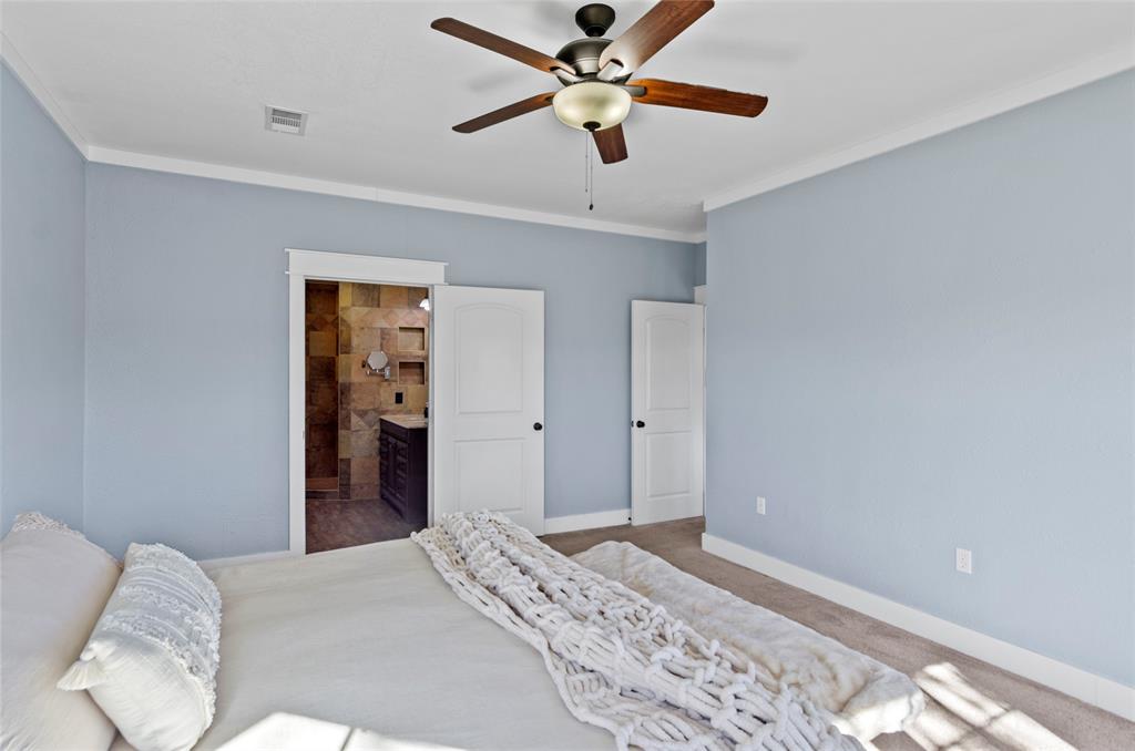 14728 Songbird Lane Haslet, TX 76052 - Photo 16 of 40 a bedroom with a bed and a ceiling fan
