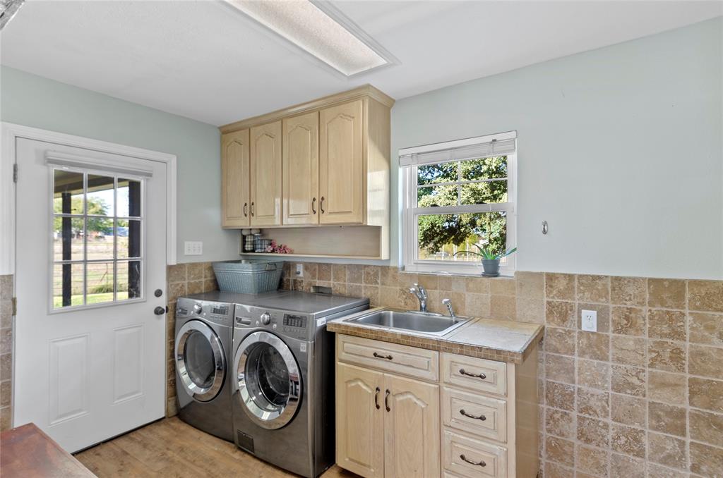 14728 Songbird Lane Haslet, TX 76052 - Photo 22 of 40 a utility room with sink dryer and washer