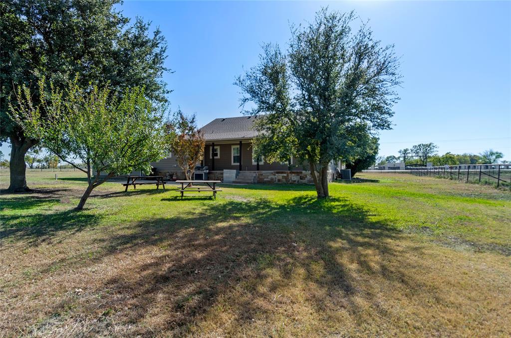 14728 Songbird Lane Haslet, TX 76052 - Photo 27 of 40 a view of a swimming pool with a yard and palm trees