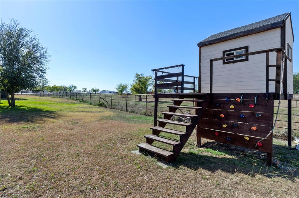 14728 Songbird Lane Haslet, TX 76052 - Photo 29 of 40 a backyard of a house with wooden fence and a bench