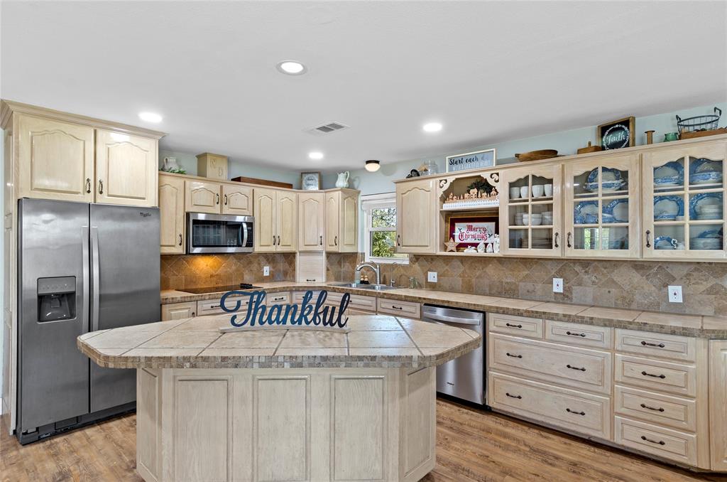 14728 Songbird Lane Haslet, TX 76052 - Photo 8 of 40 a kitchen with a stove a sink and a refrigerator