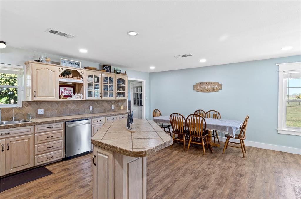 14728 Songbird Lane Haslet, TX 76052 - Photo 10 of 40 a living room with stainless steel appliances kitchen island granite countertop furniture wooden floor and a window
