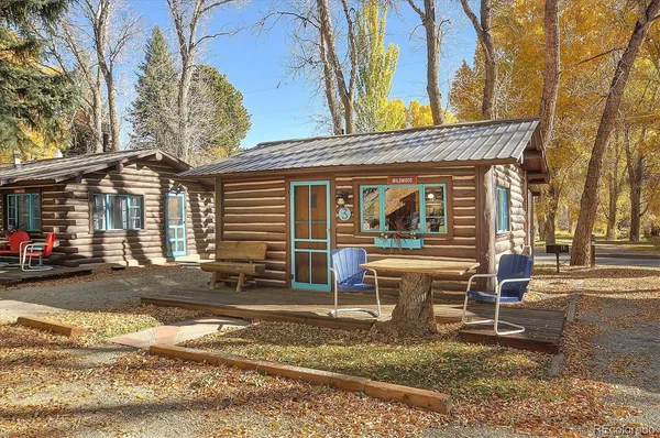 a view of a house with backyard porch and sitting area