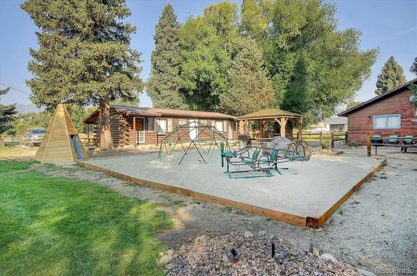 a view of a house with backyard and sitting area