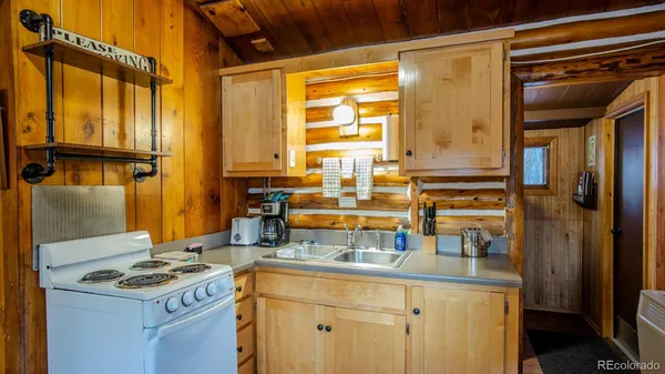 a kitchen with a sink and a refrigerator