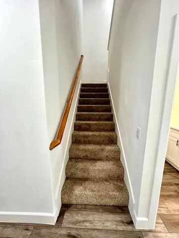 a large kitchen with stainless steel appliances a large counter top and a stove