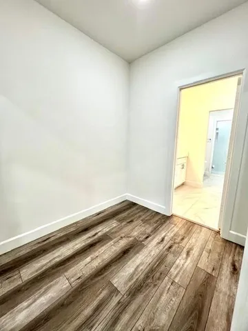 a view of a ceiling fan and wooden floor