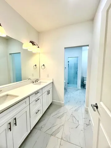 a view of a room with wooden floor