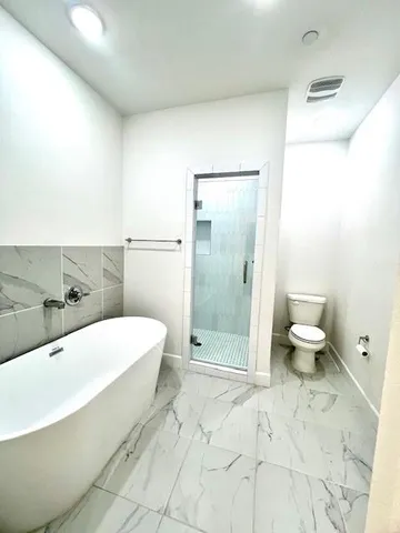 a spacious bathroom with a granite countertop sink mirror and a