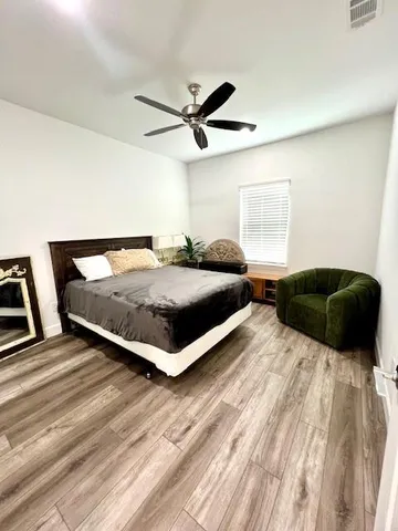 a bathroom with a double vanity sink a toilet and shower