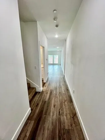 a view of a room with wooden floor