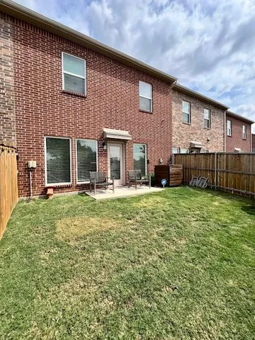 a view of a backyard with wooden fence