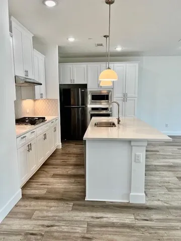 a kitchen with a sink stove and refrigerator