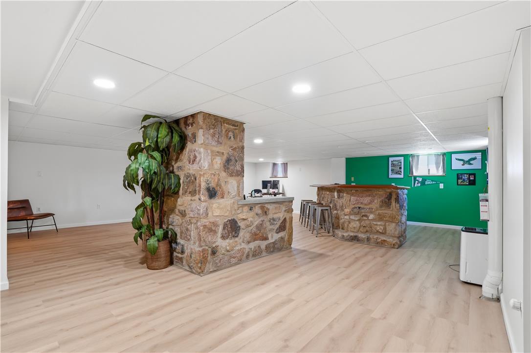 2918 Keystone Street Bethlehem, PA 18020 - Photo 23 of 54 A spacious basement recreation area boasts stone-clad bar accents and light-toned flooring.