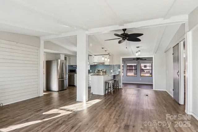a kitchen with stainless steel appliances granite countertop a refrigerator and a stove top oven