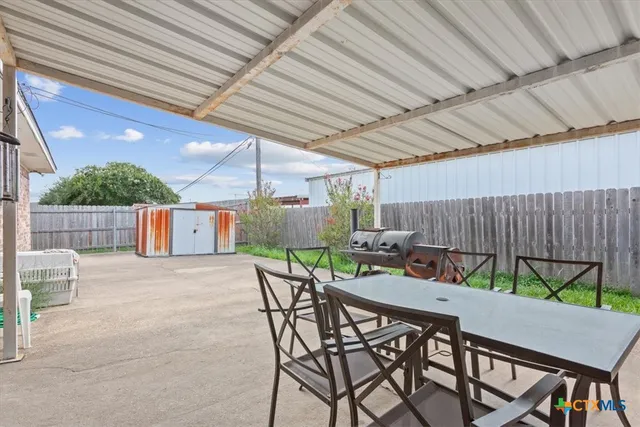 a patio with a table and chairs
