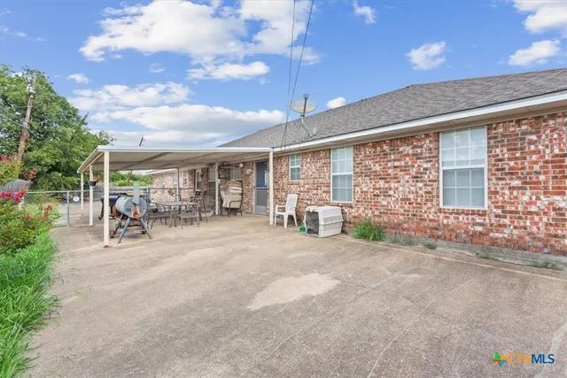 a view of a backyard with a patio