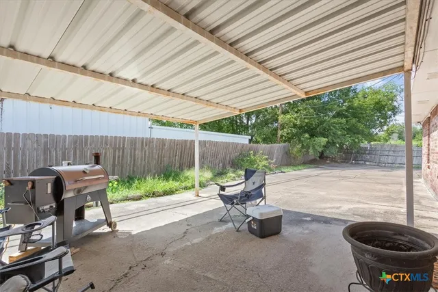 a backyard of a house with yard and outdoor seating